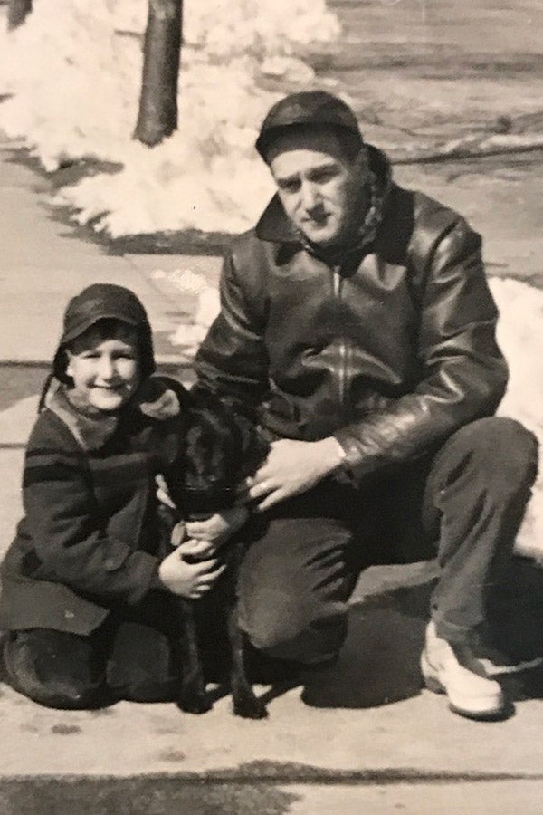 Hassan and his father in front of their house with a small dog in the 1950s.