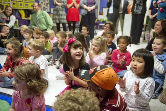 Students clap after Kathy Duritza, a pre-school teacher at the North Hills KinderCare Learning Center, is surprised with the Early Childhood Educator Award and a USD 10,000 check from Knowledge Universe on September 26, 2012 in Pittsburgh, Pennsylvania.