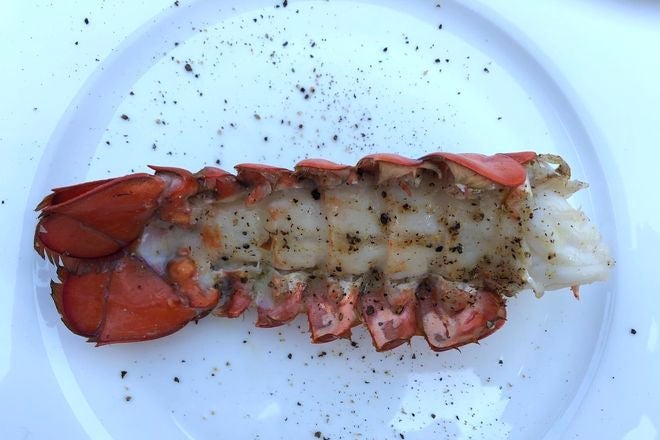 Lobster tail, meat up garnished with pepper.