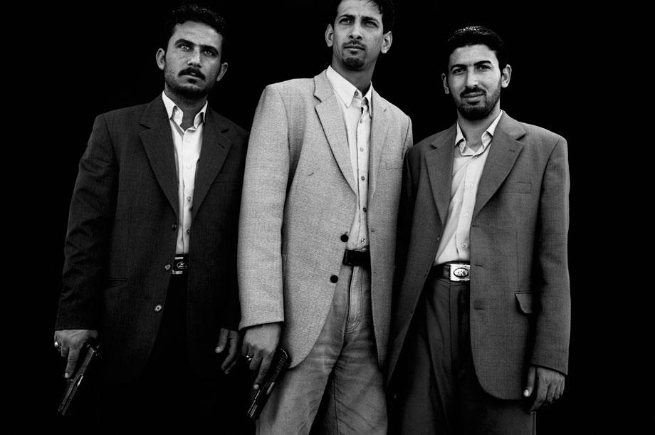 Ali Abdul Hussein, left, Mohammed Abdul Redha, center, and Ahmed Khalaf, right, Shiites loyal to Muqtada al Sadr, stand for a portrait in Baghdad, Iraq on March 2, 2006. They work in the local office of Muqtada Al Sadr who, after a Sunni mosque was attacked, helped to secure it. The invasion of Iraq broke a community into sectarian halves, at each other?s throats: Sunni and Shiite, who have lived together -- albeit not in perfect harmony -- for 1400 years became mortal enemies, killing each other?s women and children.
