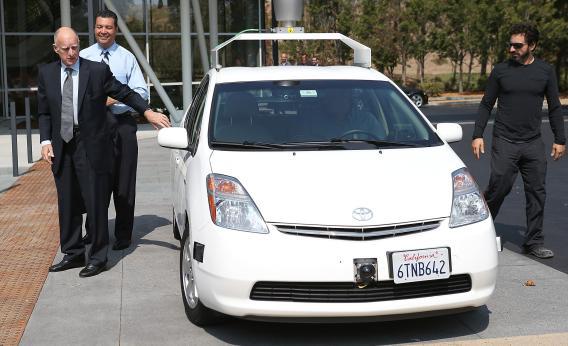 California Gov. Jerry Brown, California State Sen. Alex Padilla, and Google co-founder Sergey Brin exit a self-driving car at the Google headquarters on Sept. 25.