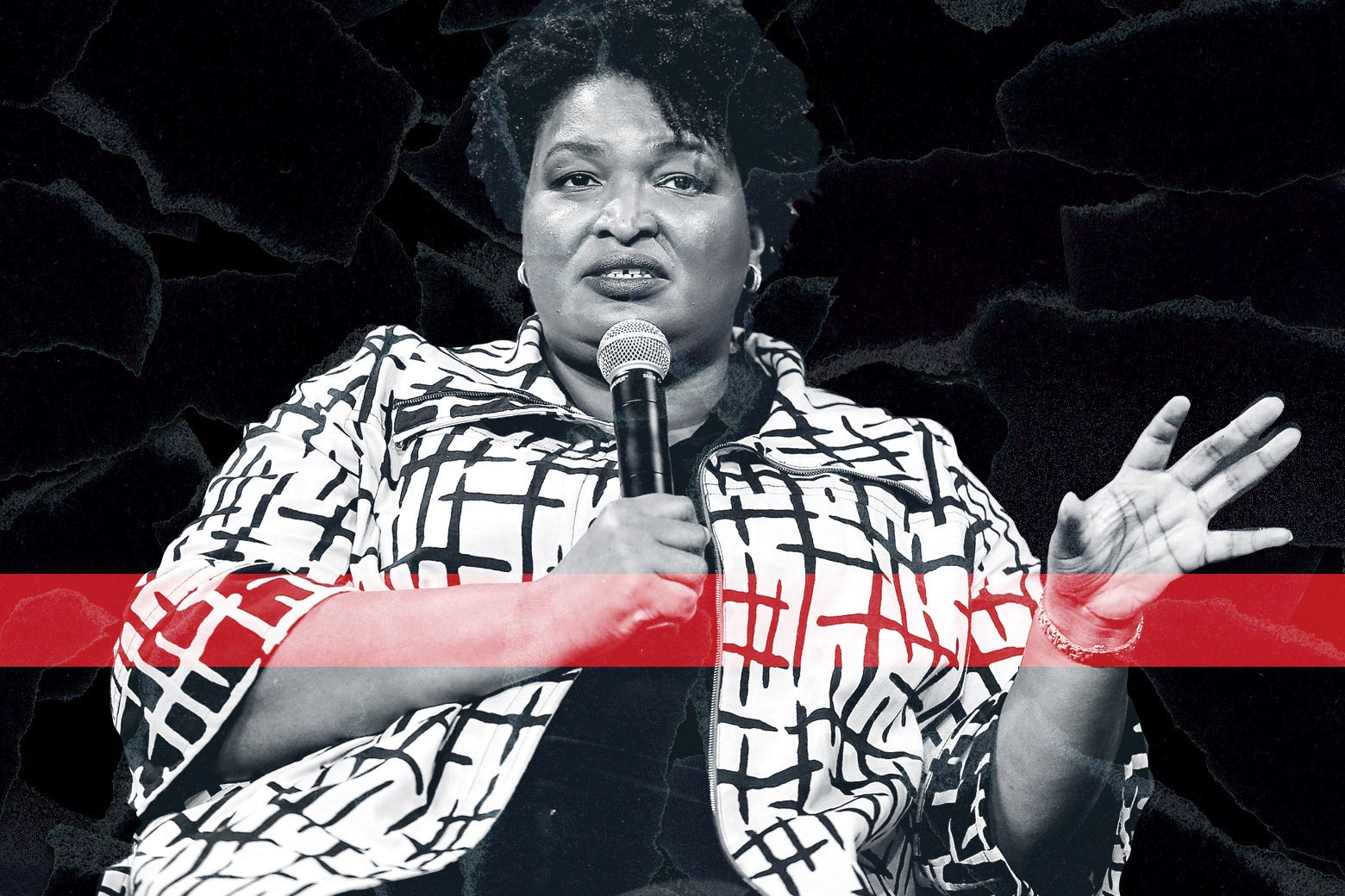 Stacey Abrams holds a microphone.
