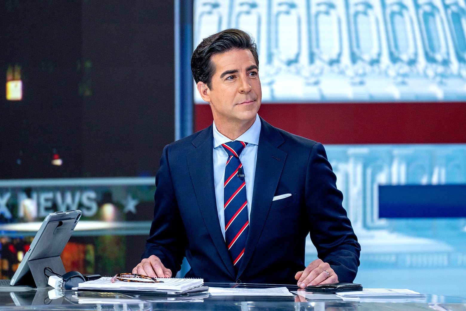 Jesse Watter sits at a desk in the Fox News studio.