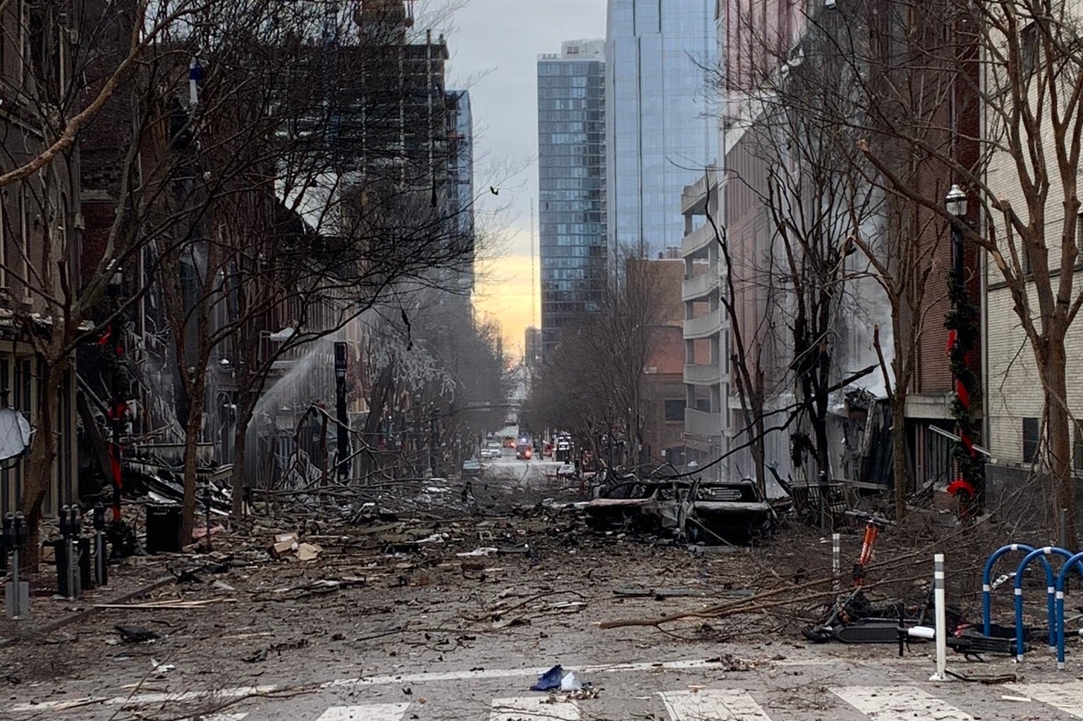 Branches and rubble strewn across a city street