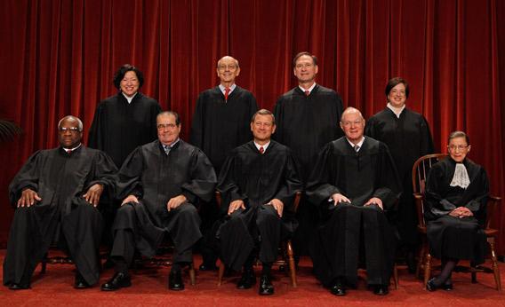 U.S. Supreme Court members pose for photographs. 