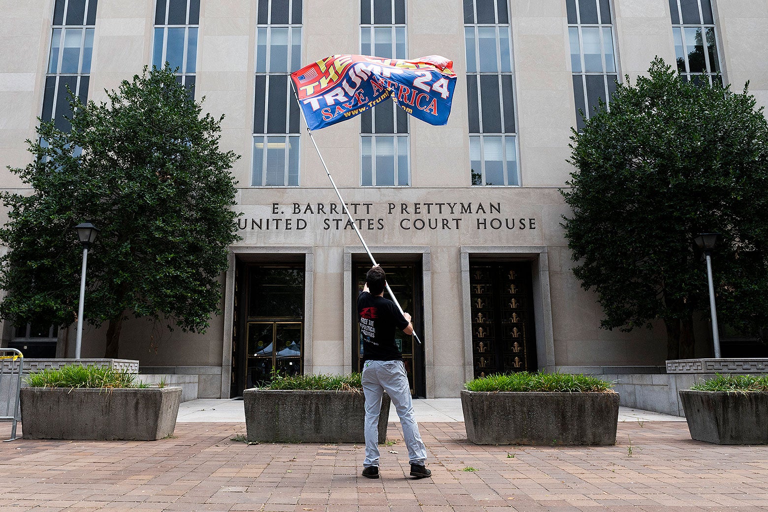 A man waves a pro-Trump flag in front of the E. Barrett Prettyman United States Courthouse in Washington D.C. on Thursday.