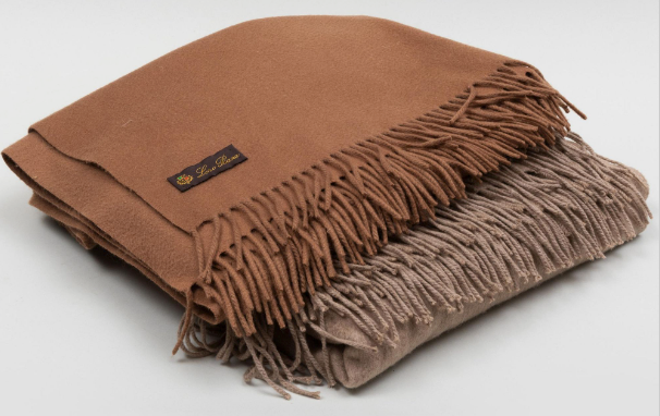 Two brown shawls in a pile. 
