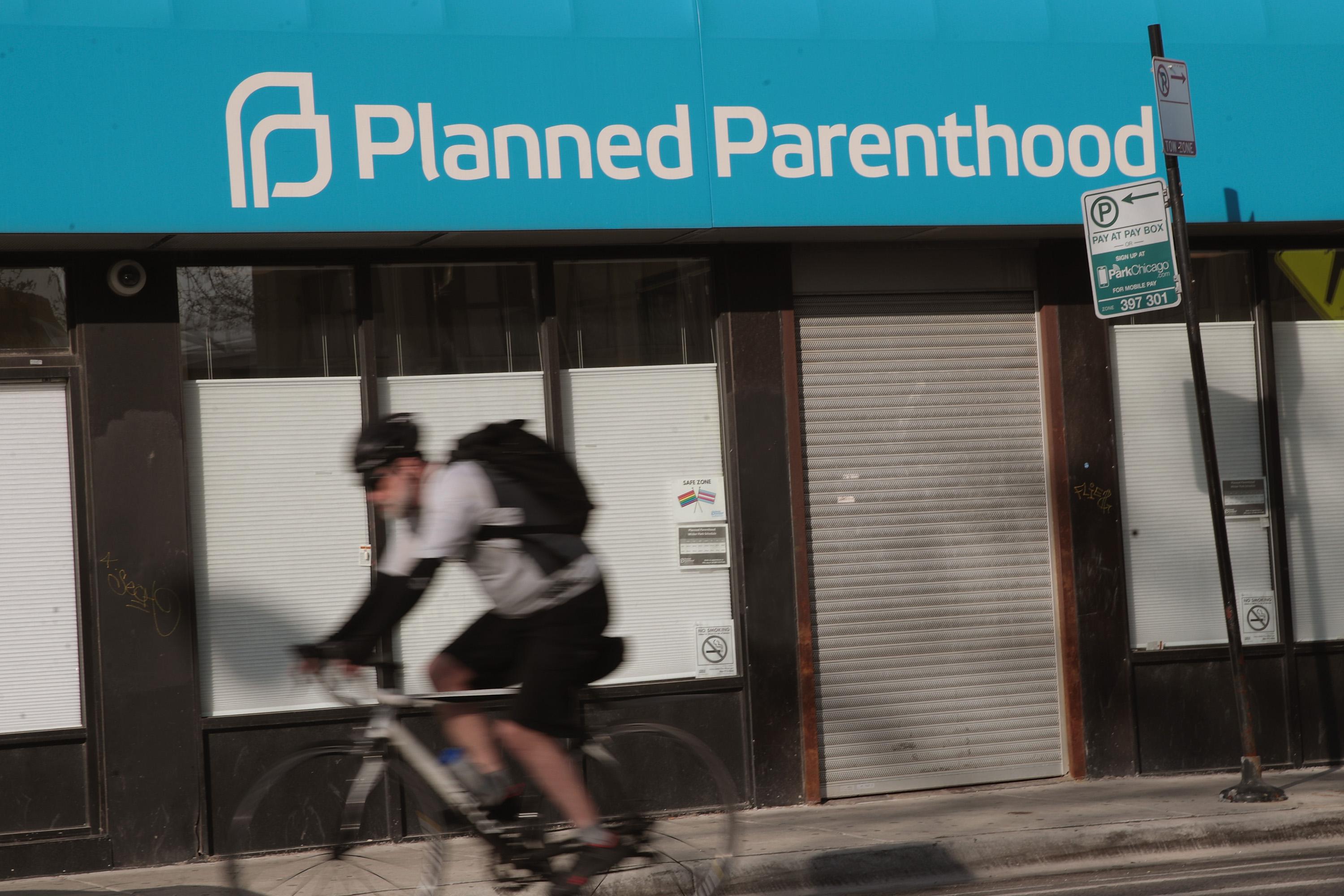 CHICAGO, IL - MAY 18:  A cyclist rides past a Planned Parenthood clinic on May 18, 2018 in Chicago, Illinois. The Trump administration is expected to announce a plan for massive funding cuts to Planned Parenthood and other taxpayer-backed abortion providers by reinstating a Reagan-era rule that prohibits federal funding from going to clinics that discuss abortion with women or that share space with abortion providers.  (Photo by Scott Olson/Getty Images)