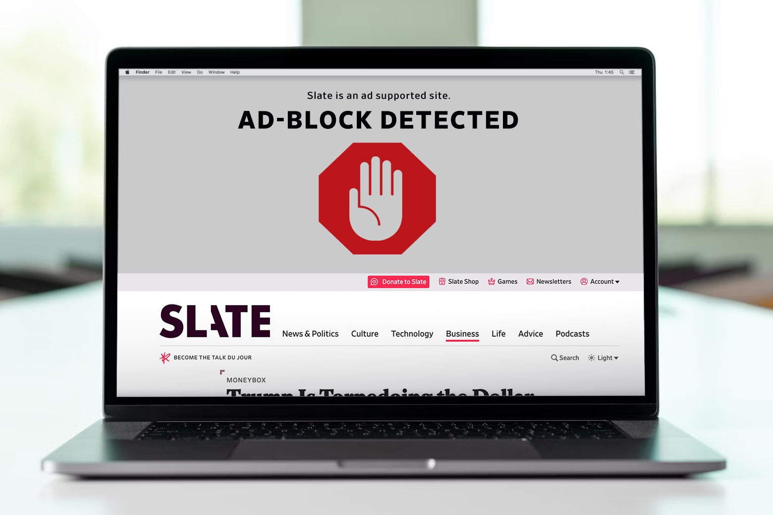 Laptop open with an ad blocker on the screen.