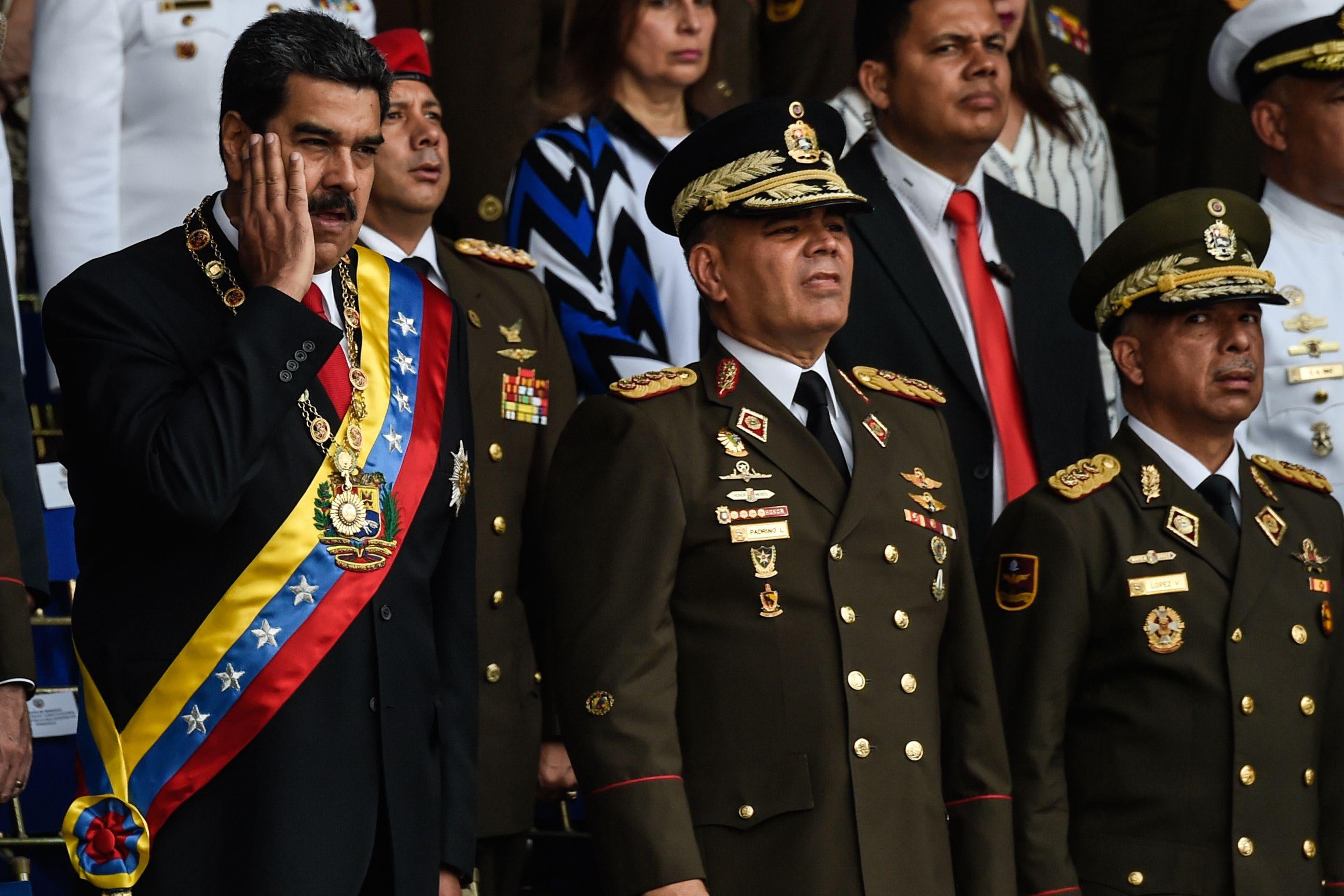 Venezuelan President Nicolas Maduro (L) gestures next to Minister of Defence General Vladimir Padrino (C), during a ceremony to celebrate the 81st anniversary of the National Guard in Caracas on August 4, 2018. 
