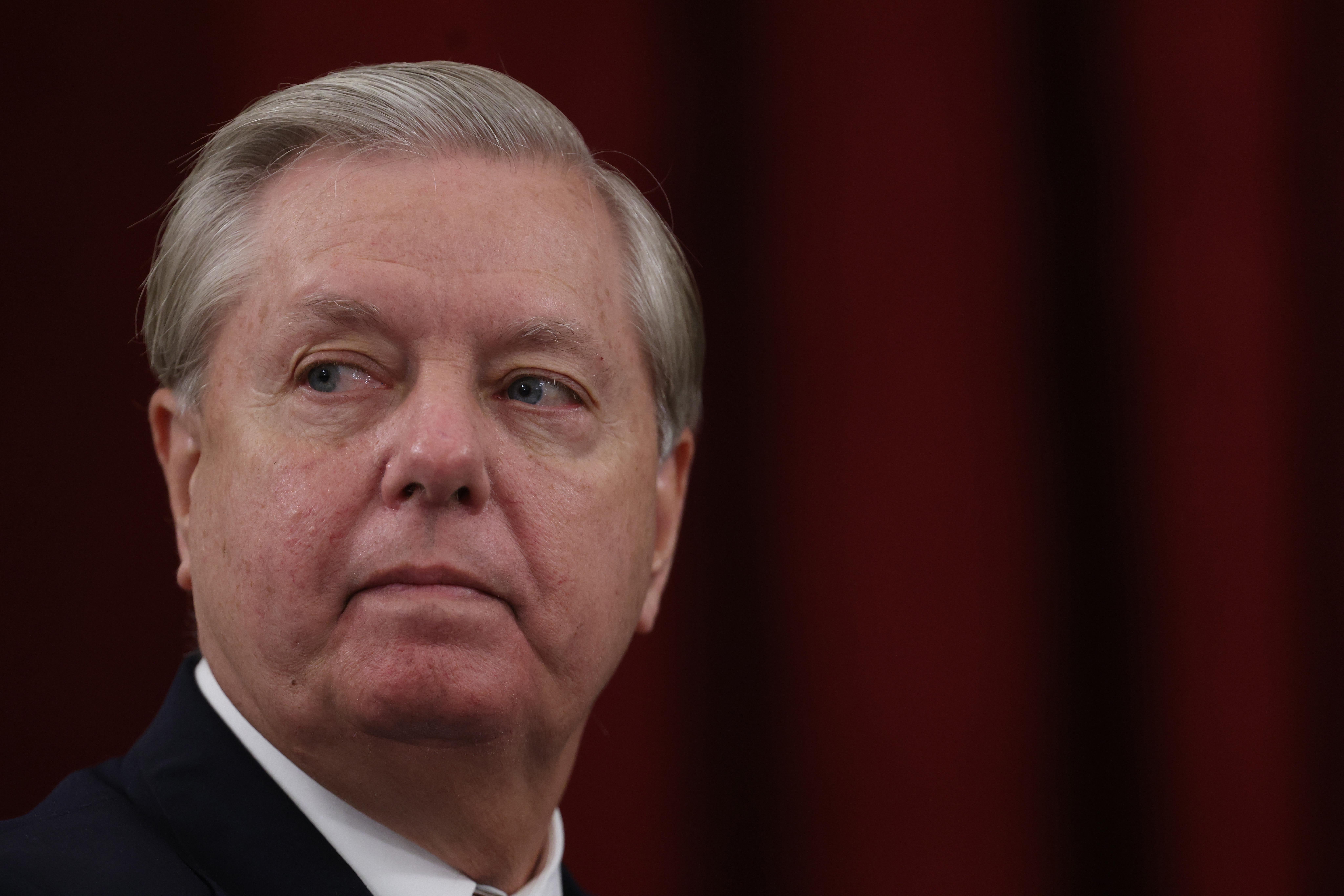 Lindsey Graham looks at something.