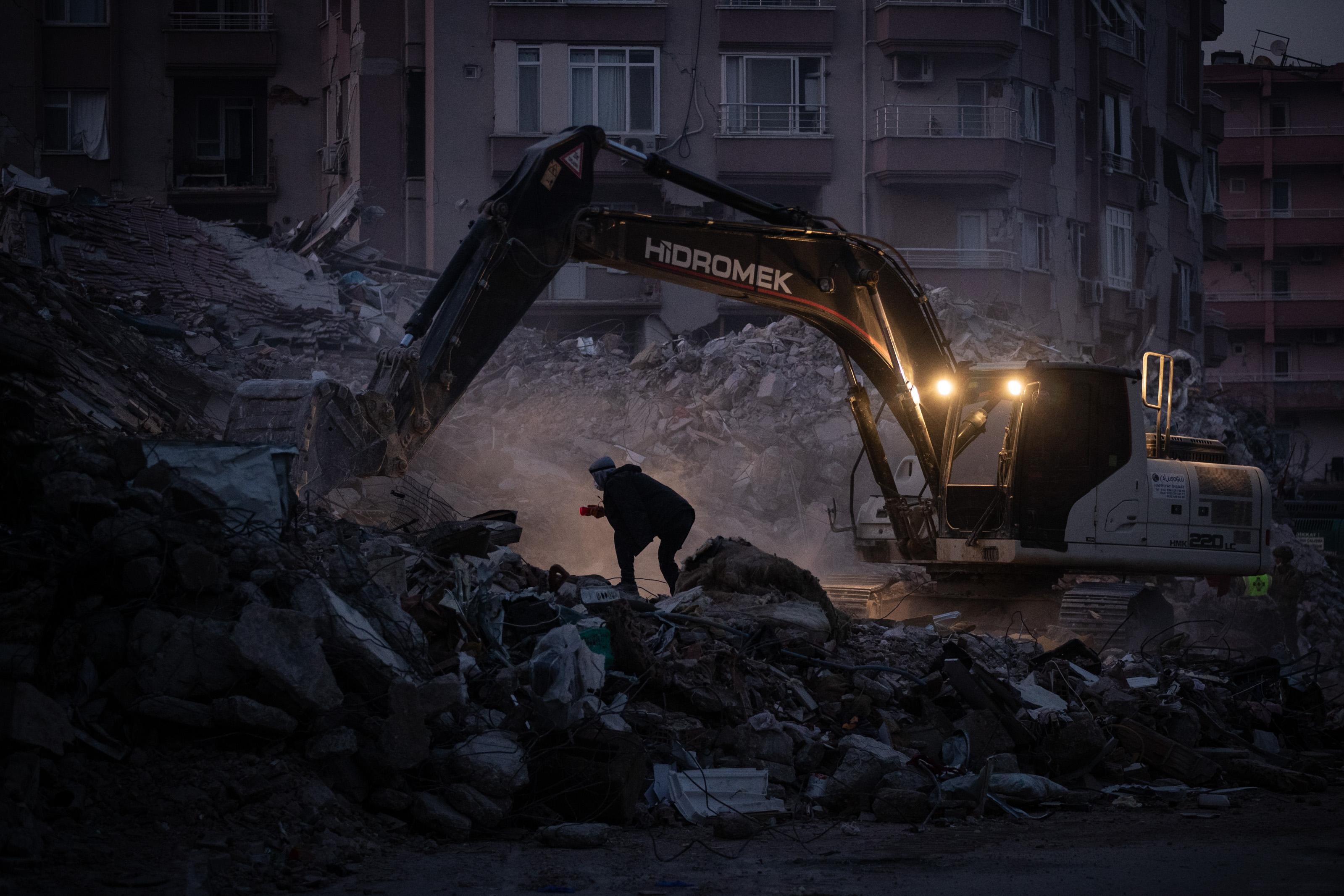 A machine digs through rubble in Turkey.