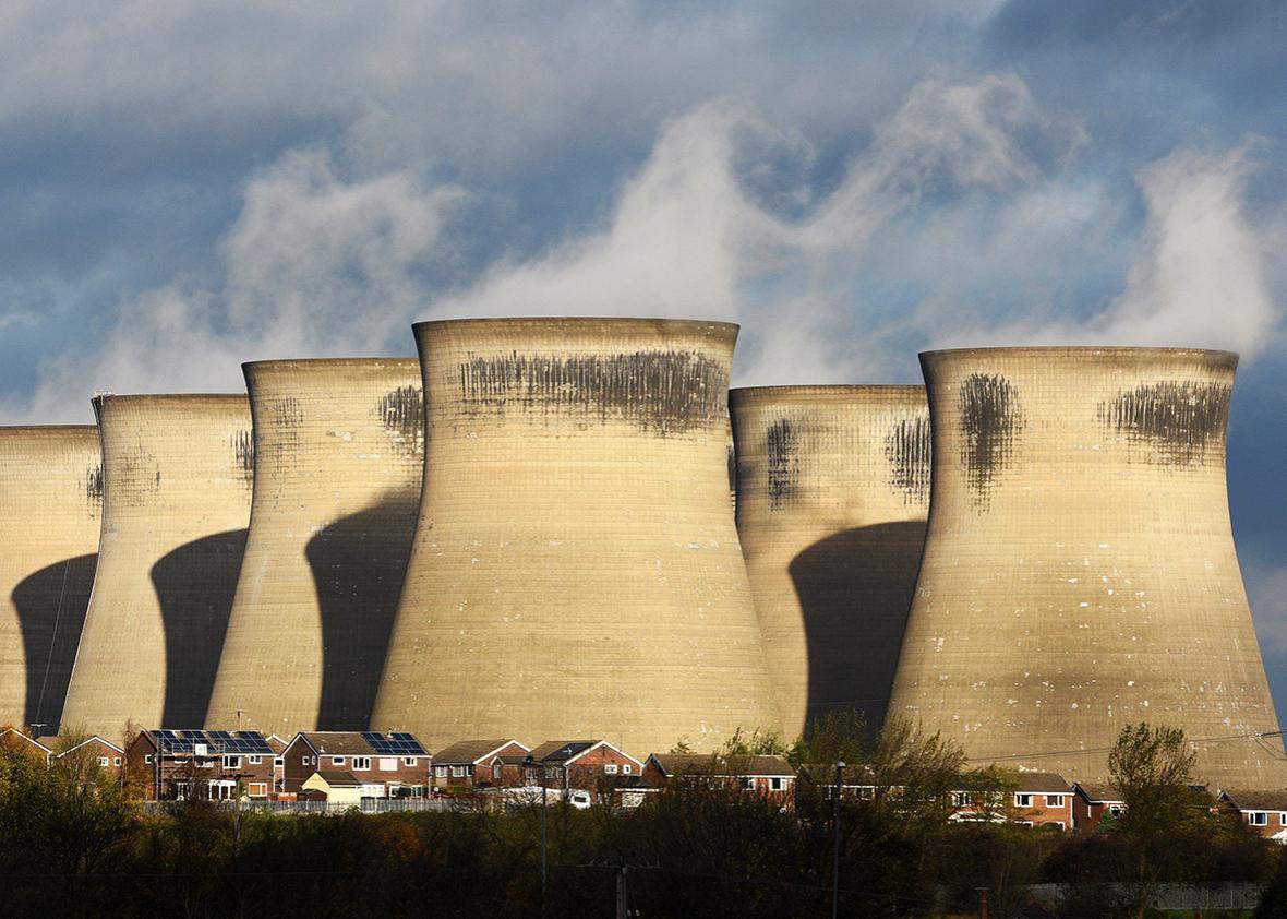 A general view shows a residential estate in front of the coal fired Ferrybridge C power station, near Knottingley in northern England, on November 10, 2015. 