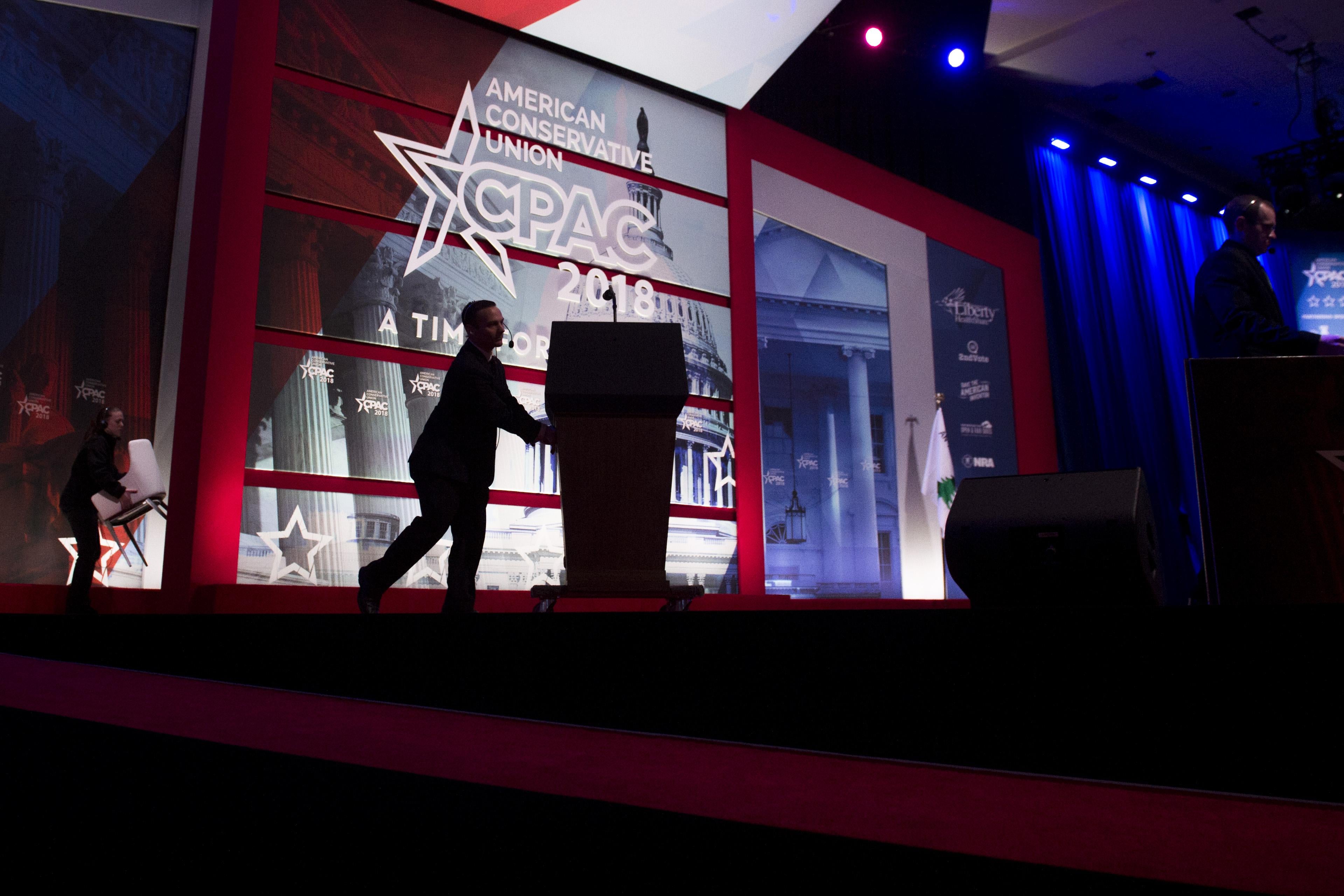 Staffers bring out a podium at the 2018 Conservative Political Action Conference.