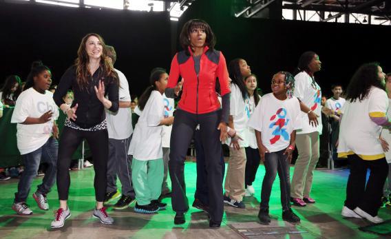 First lady Michelle Obama dances with school children at a "Let's Move!" event.