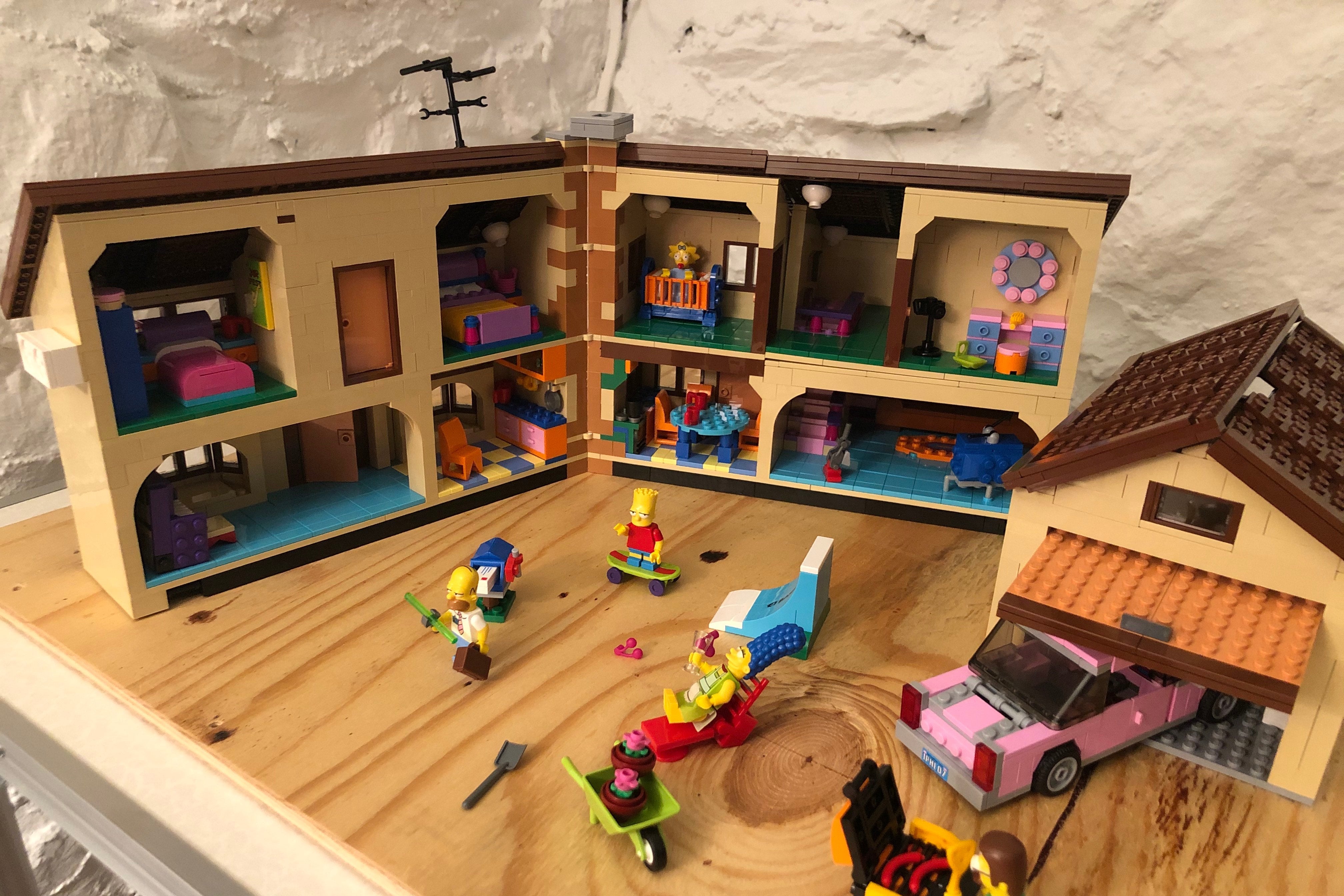 A photo of 742 Evergreen Terrace, in cross-section, showing such details as everyone's bedrooms, the iconic orange couch, and Ned Flanders