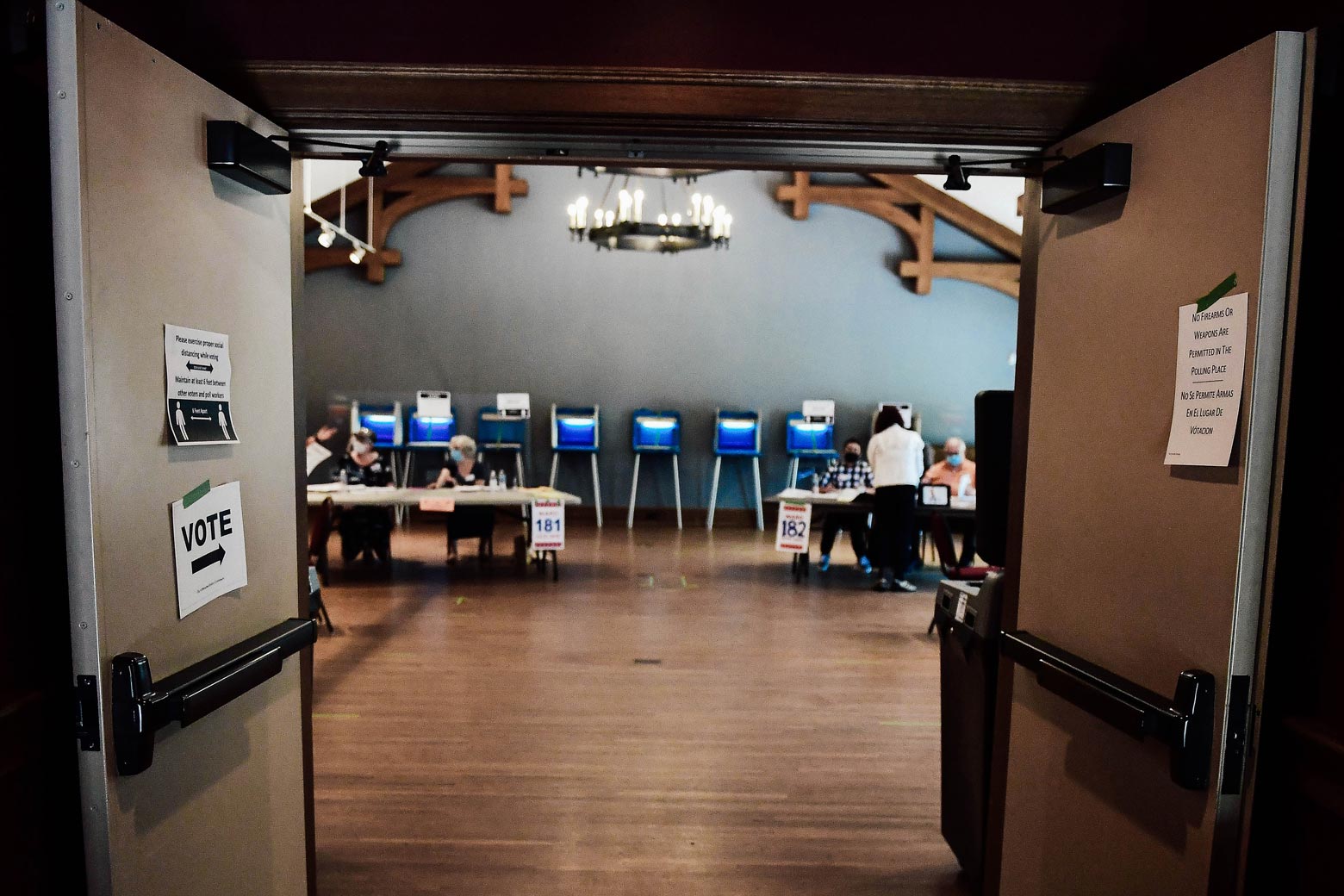 Doors open to a polling site with tables and booths