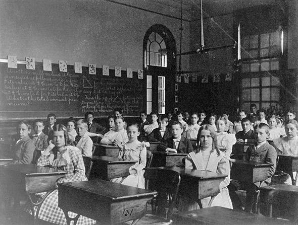 Girls and boys seated at desks in Washington, D.C. classroom, circa 1899.