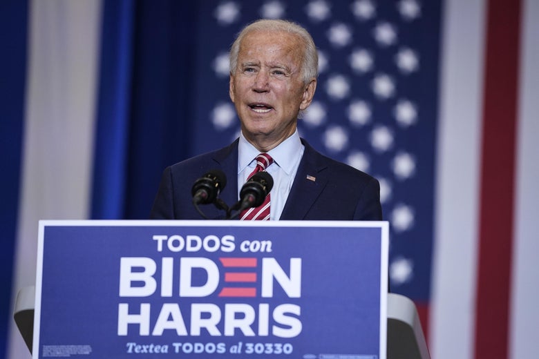 Biden speaks at a podium that says "Todos con Biden Harris"