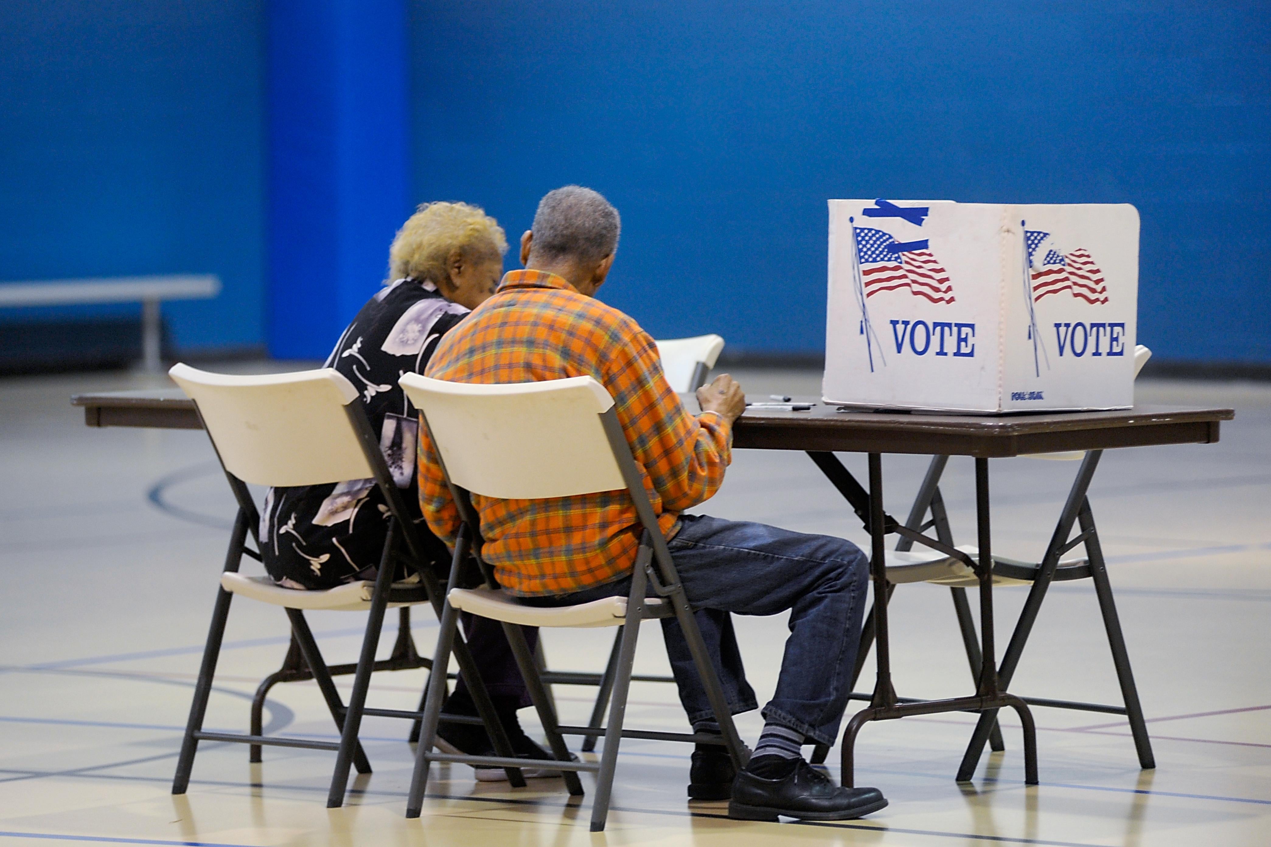 A couple reads a ballot prior to voting on Nov. 8, 2016 in Durham, North Carolina.