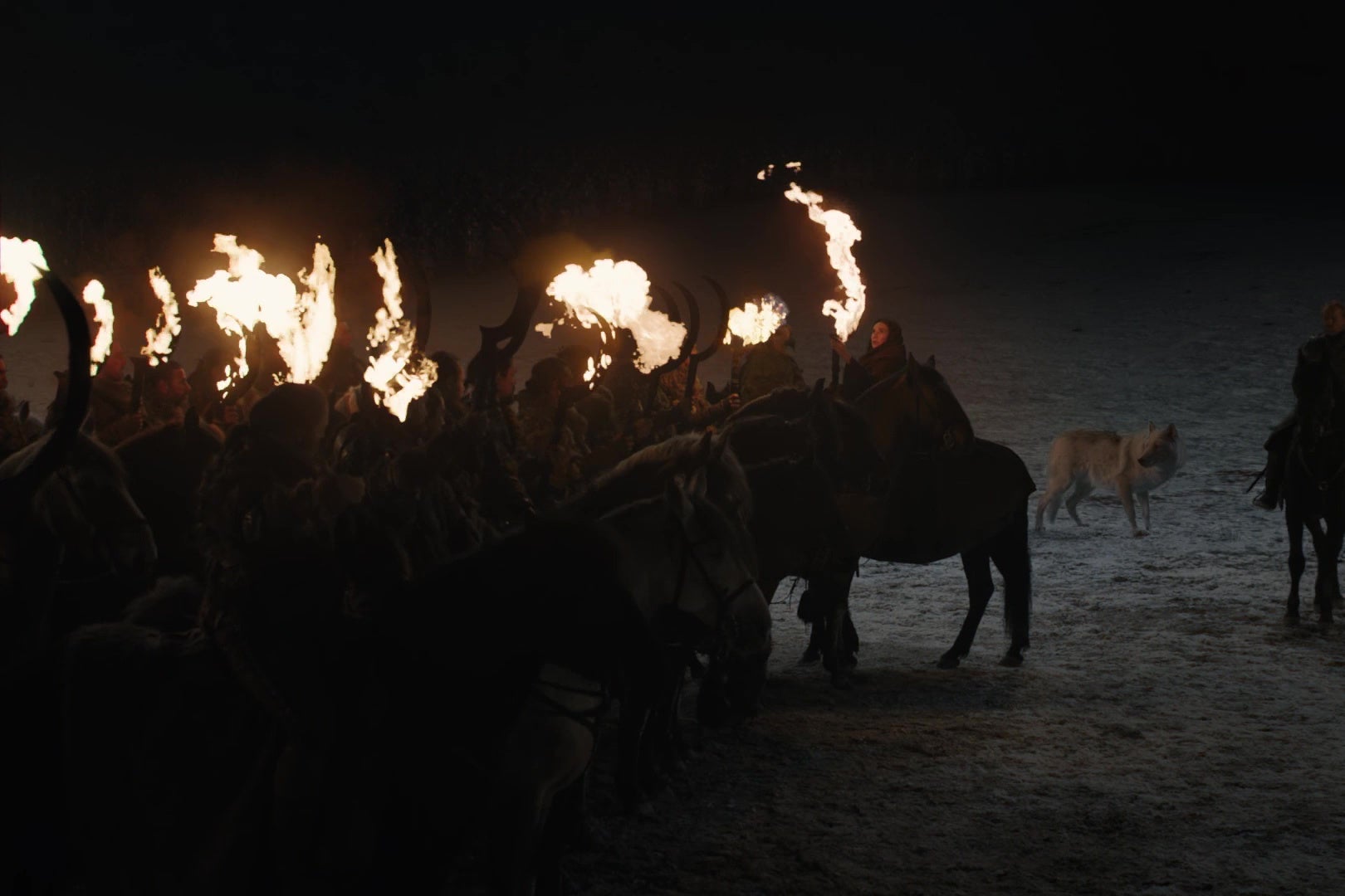 Melisandre sets a group of Dothraki swords on fire.