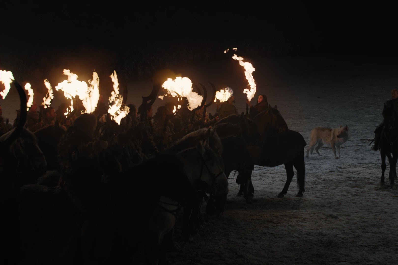 Melisandre sets a group of Dothraki swords on fire.