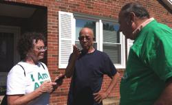Gail and Steve Koroupis, volunteers with Americans for Prosperity, talk to Leesburg voter Patrick Henry.