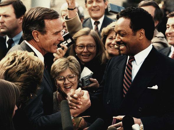 Former president-elect George Bush(L) as shakes hands with the Rev. Jesse Jackson(R), 30 November 1988 after a luncheon meeting at the White House in Washington,DC.