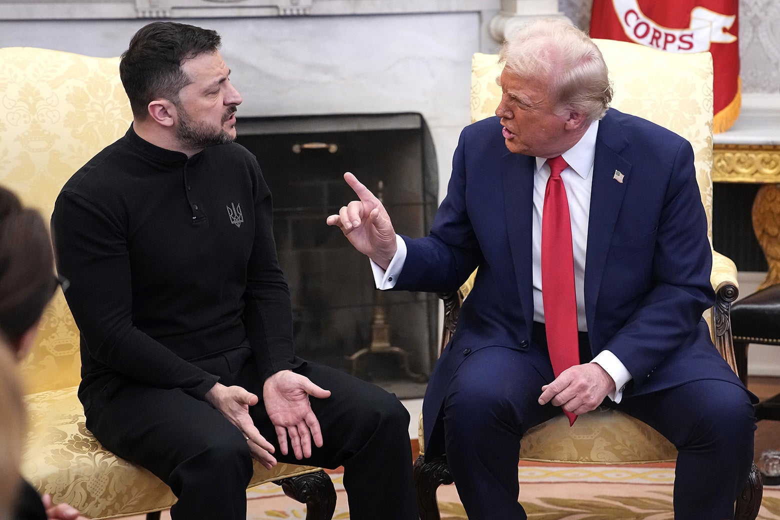 Donald Trump redfaced and wagging his finger in the face of Volodymyr Zelensky, who looks calm but angry.