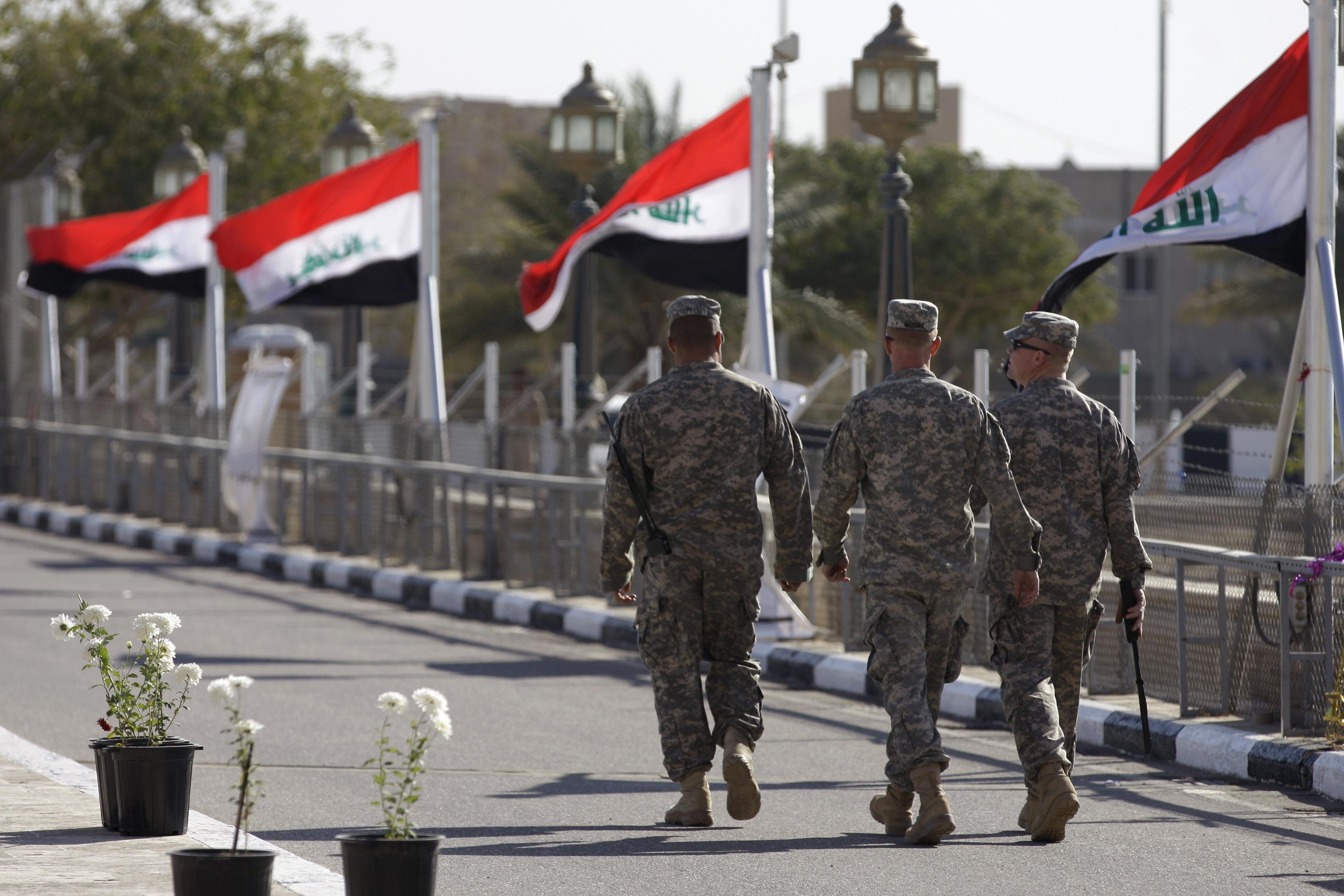 Iraqi flags fly in the wind as US soldiers leave Al-Fao palace at Camp Victory, one of the last US bases Iraq, after a special ceremony in Baghdad on December 1, 2011. The United States handed over to Iraqi control the sprawling Victory Base Complex near Baghdad, the main base from which the US war in Iraq was run, a US military spokesman said on December 2, 2011.
AFP PHOTO/POOL/KHALID MOHAMMED (Photo credit should read KHALID MOHAMMED/AFP/Getty Images)