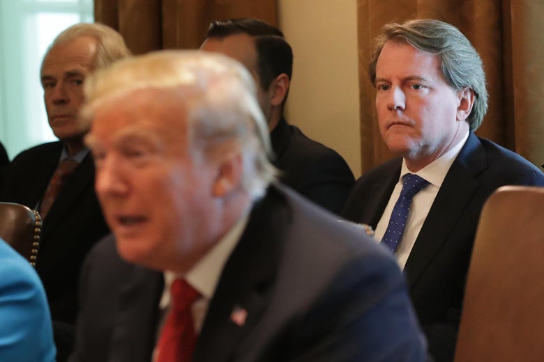 Don McGahn sitting behind President Trump at a conference table