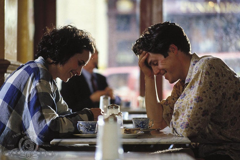 Andie MacDowell and Hugh Grant sit at a table.