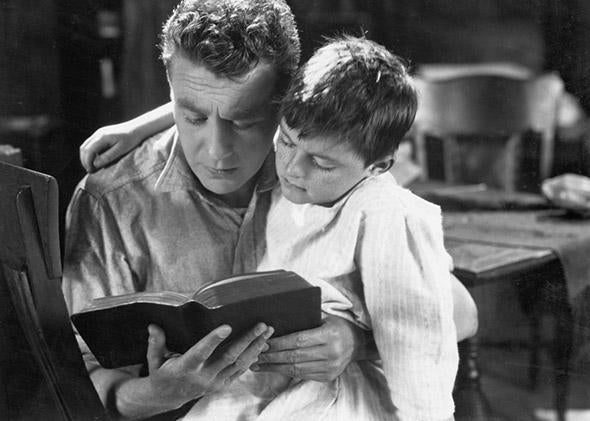 Child and father reading together