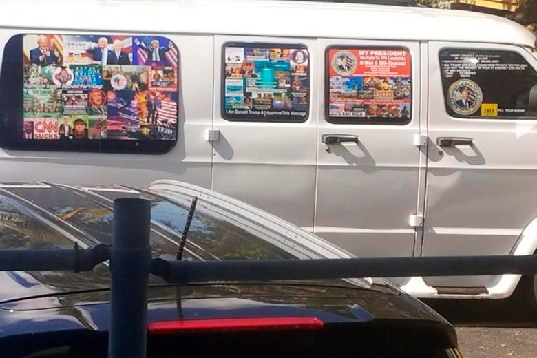 A van with windows covered with an assortment of stickers.