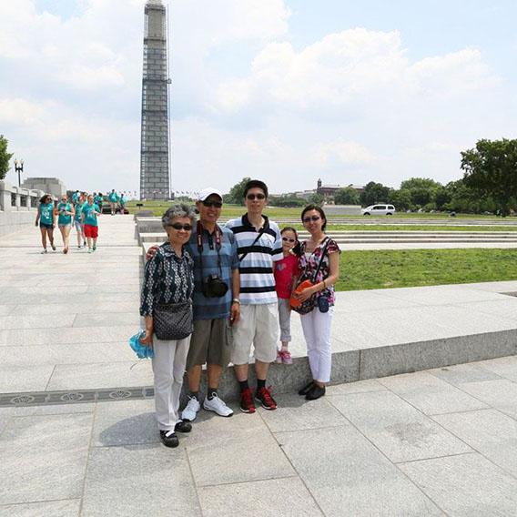 A visiting family from Japan posing at the World War II memorial.