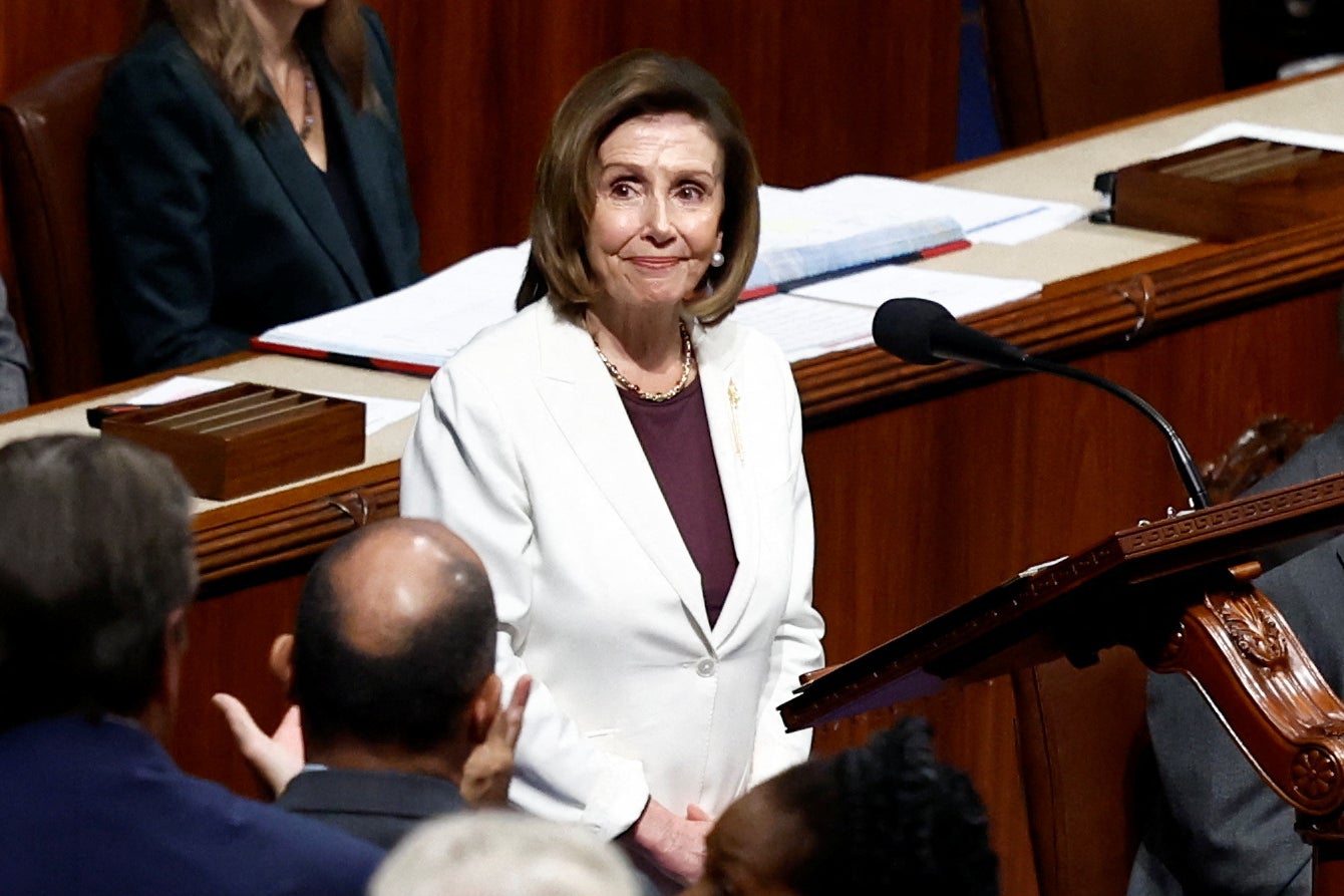 U.S. House Speaker Nancy Pelosi stands behind a podium and listens to applause from her House colleagues after she announced that she will remain in Congress but will not run for re-election as Speaker of the House.