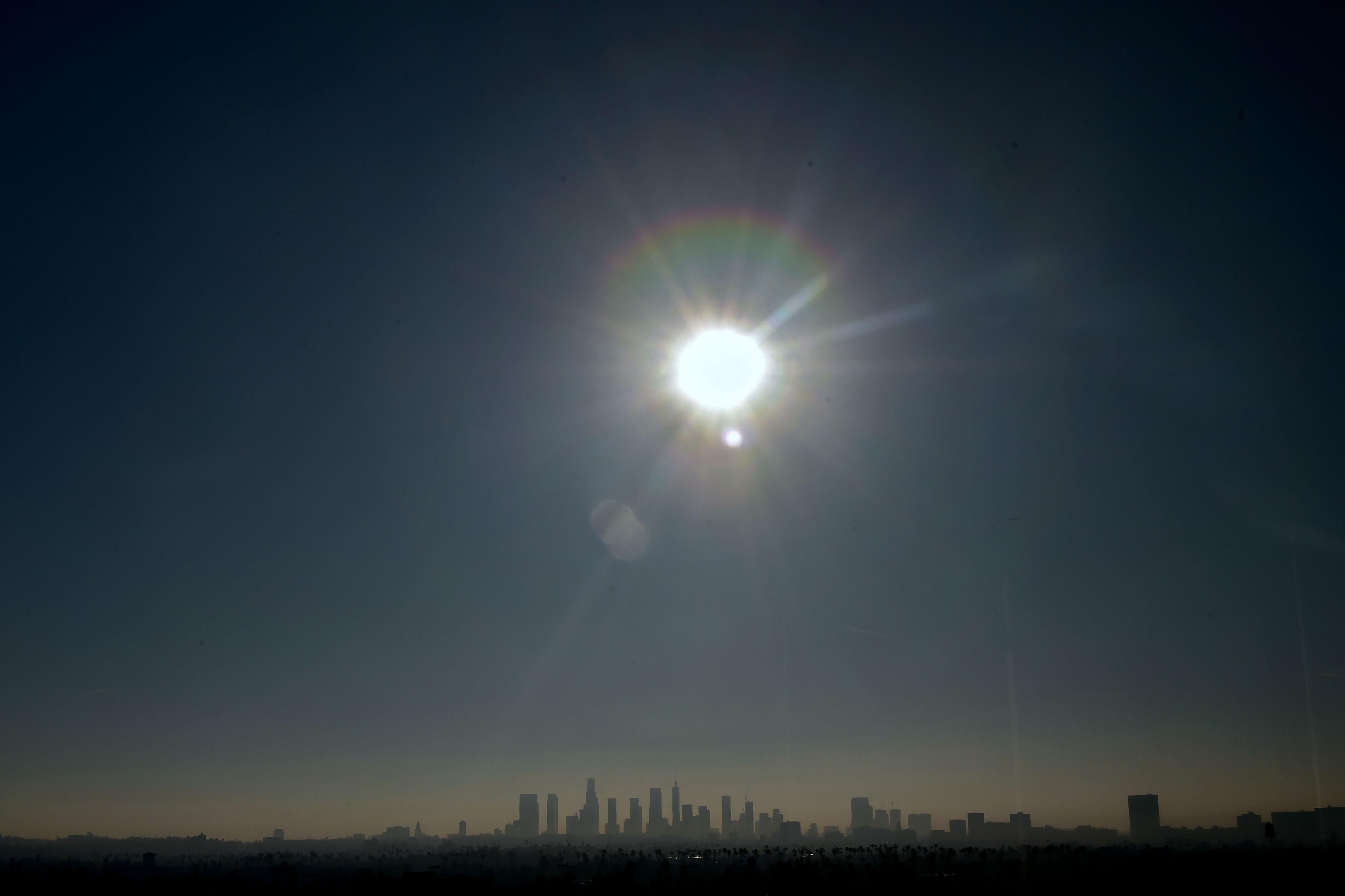 The sun shines over the Los Angeles skyline on January 5, 2018. 
A building boom not seen since the 1920's is underway with the construction of new concrete and glass towers. / AFP PHOTO / FREDERIC J. BROWN        (Photo credit should read FREDERIC J. BROWN/AFP/Getty Images)