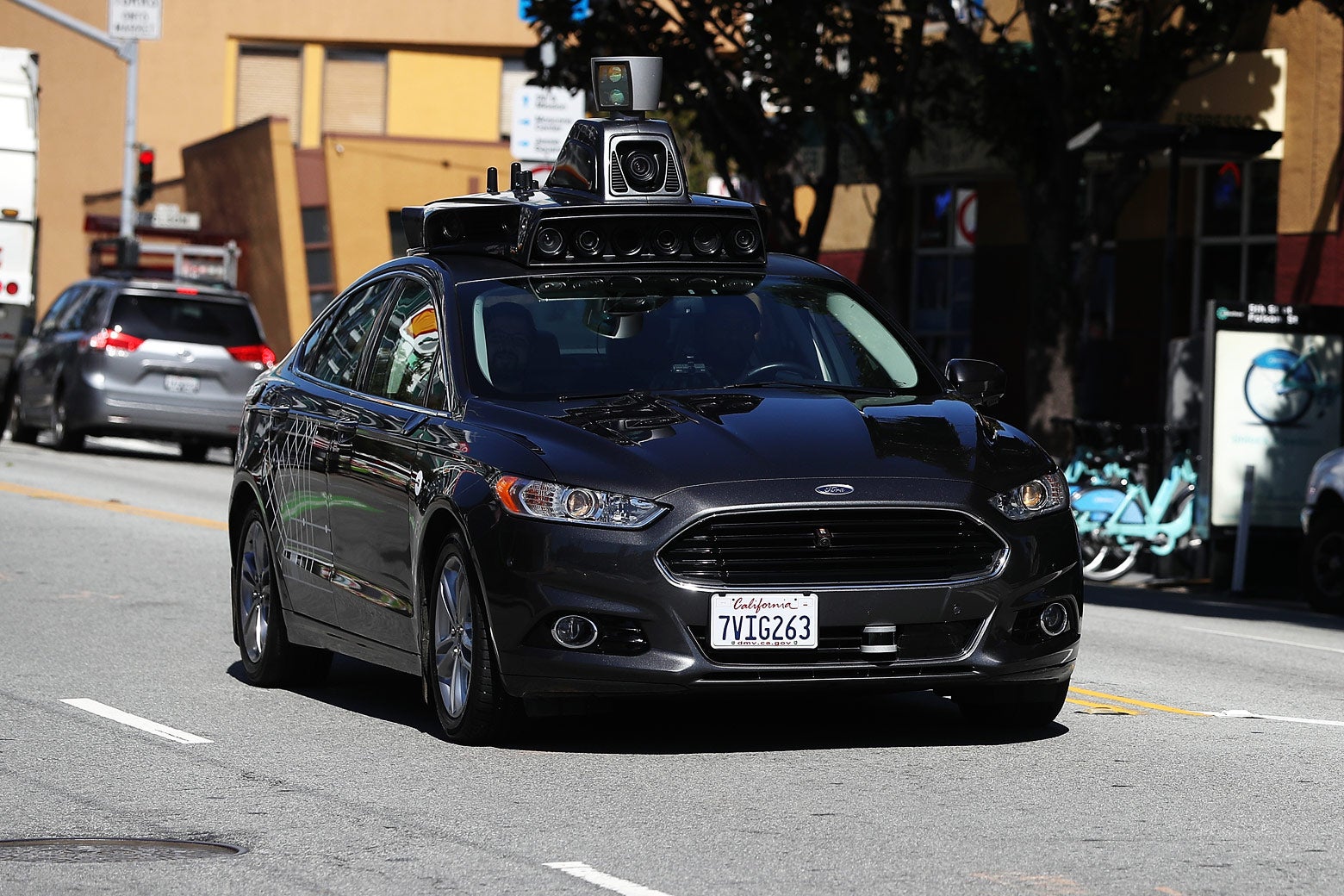 An Uber self-driving car drives down the street.