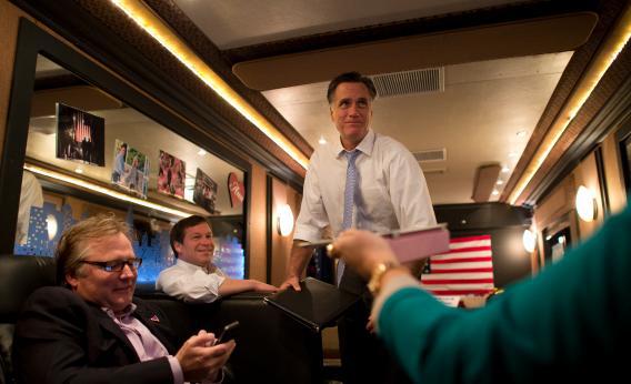 Mitt Romney rides aboard his campaign bus with Congressman Connie Mack and senior advisor Eric Fehrnstrom.
