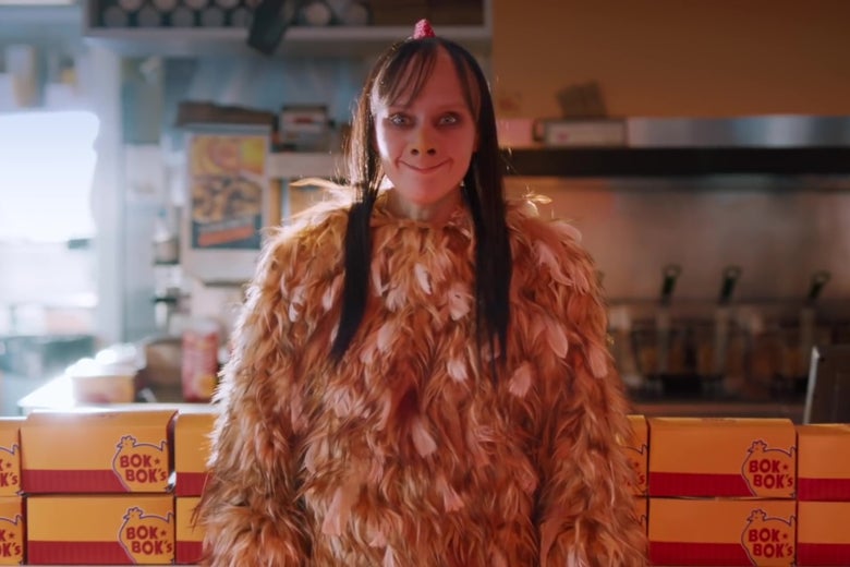 Kate McKinnon, dressed as a creepy fast food chicken mascot with an uncanny resemblance to internet hoax Momo.