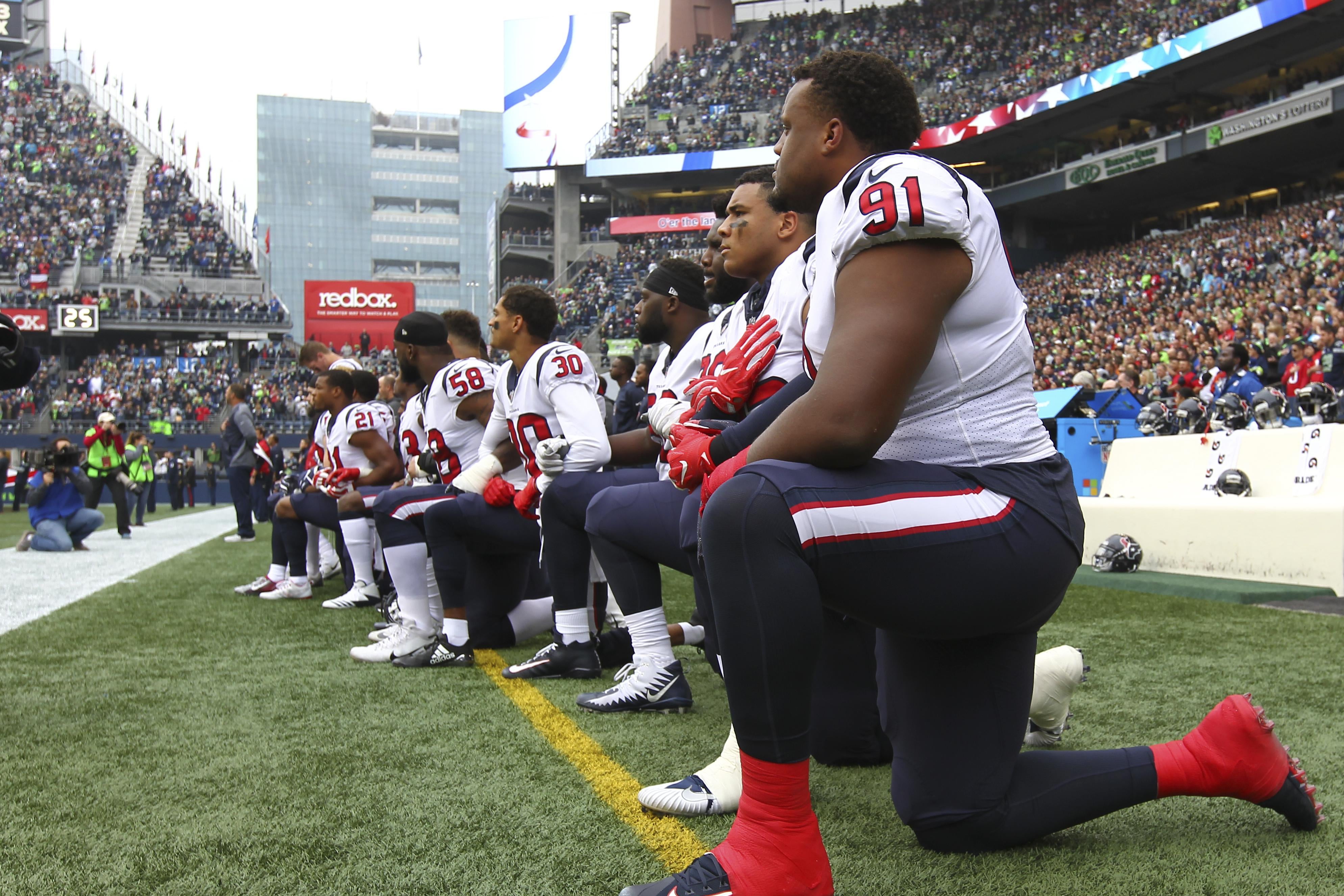 Members of the Houston Texans kneel during the national anthem before the game against the Seattle Seahawks at CenturyLink Field on October 29, 2017 in Seattle, Washington. 