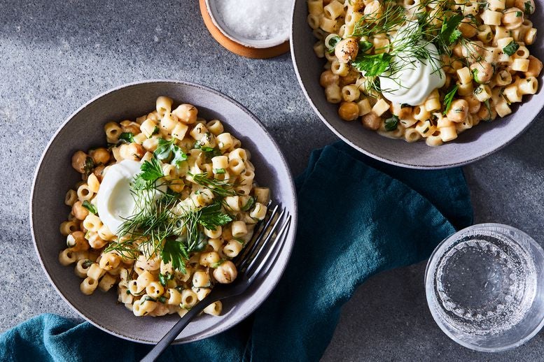 Two bowls of ditalini with herbs, chickpeas, and yogurt