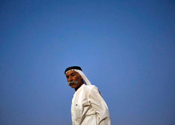 Abu Aziz stands outside his tent in the village of al-Arakib, one of the dozens of ramshackle Bedouin Arab communities in the Negev desert which are not recognised by the Israeli state, in southern Israel August 18, 2013. 
