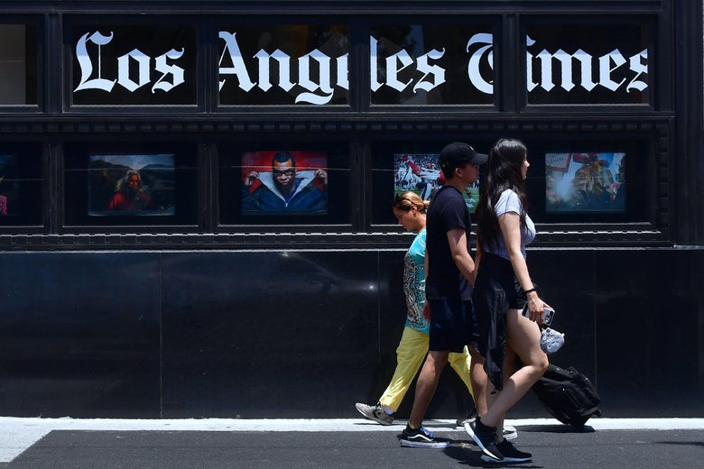 Pedestrians walk past the Los Angeles Times office building.
