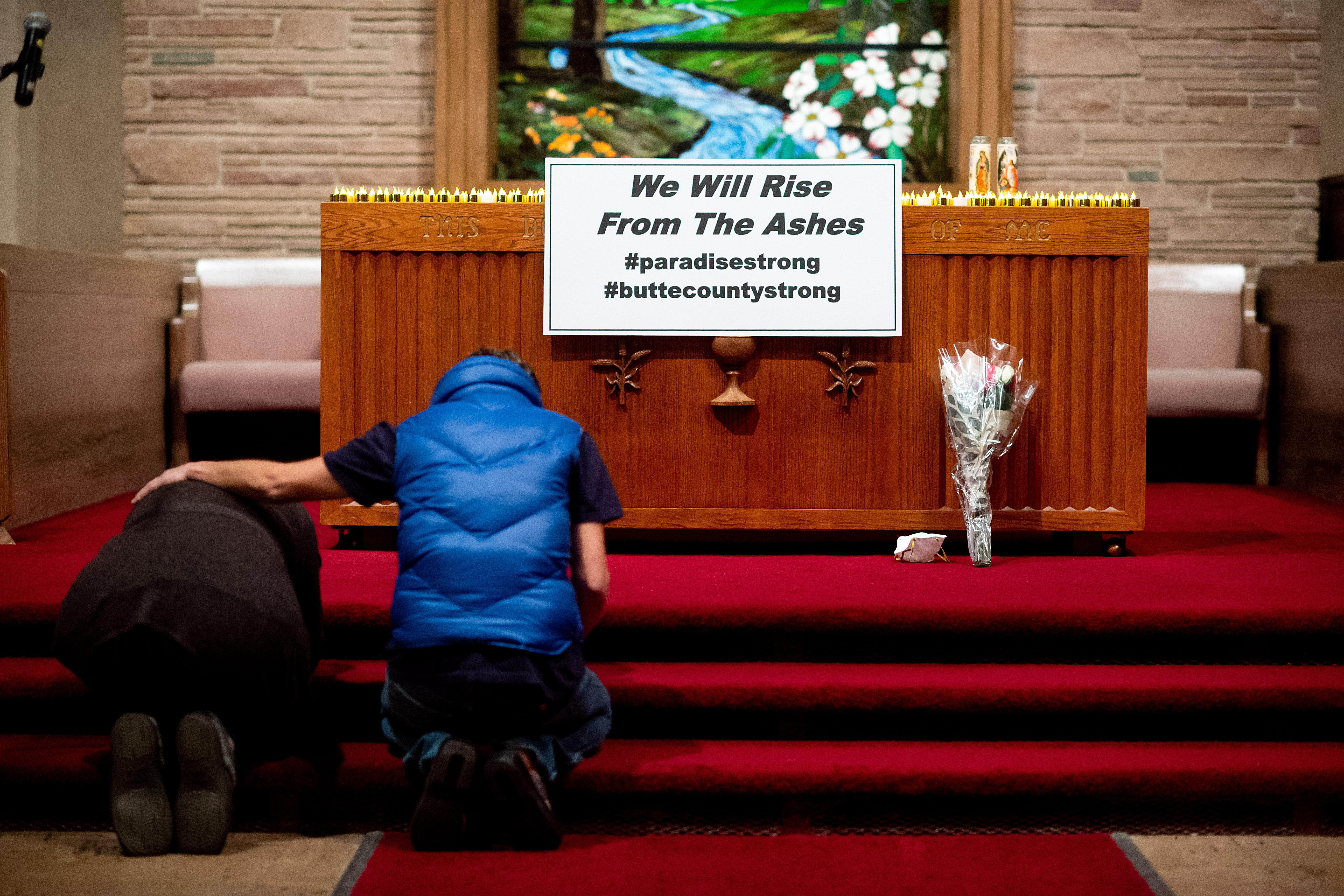 CHICO, CA - NOVEMBER 18: Mourners pray during a vigil for Camp Fire victims at the First Christian Church of Chico on November 18, 2018 in Chico, California. The blaze has killed at least 76 people and destroyed more than 10,000 structures according to Cal Fire. (Photo by Noah Berger-Pool/Getty Images)