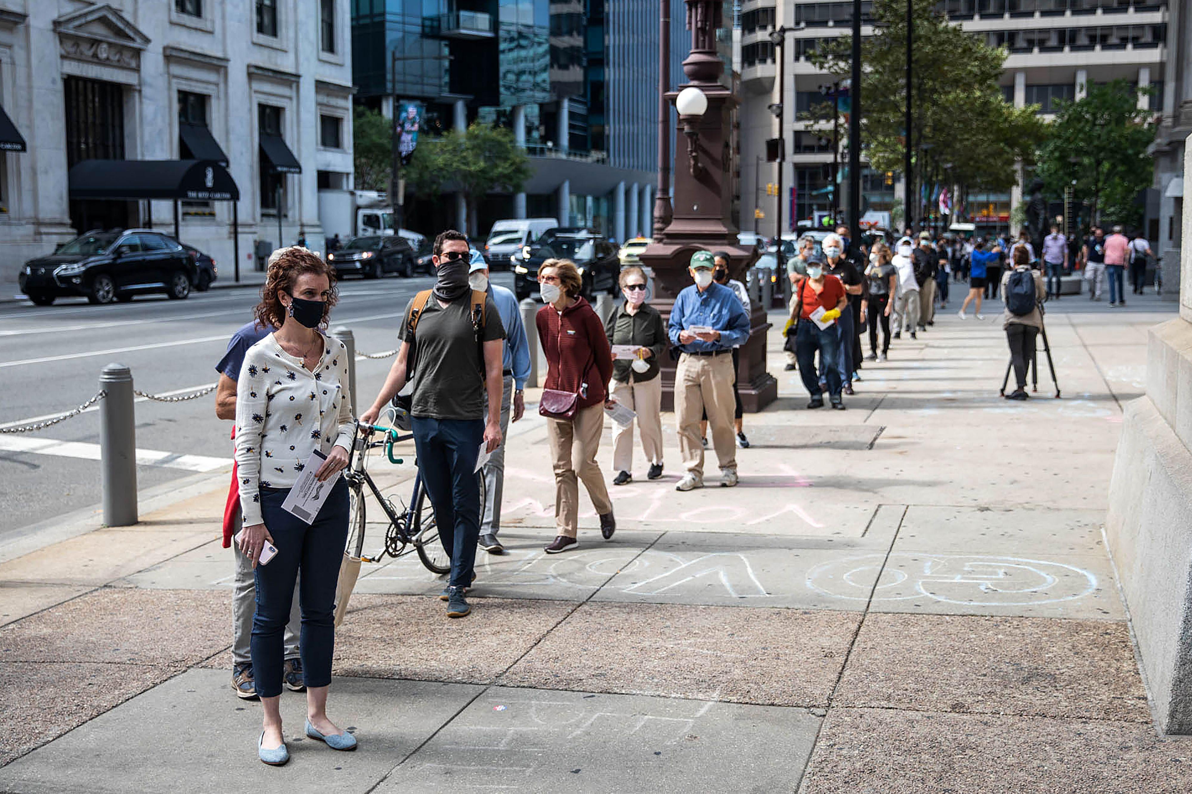 People wait in line to cast their vote during early voting at City Hall in Philadelphia, Pennsylvania on October 7, 2020. (Photo by GABRIELLA AUDI / AFP) (Photo by GABRIELLA AUDI/AFP via Getty Images)