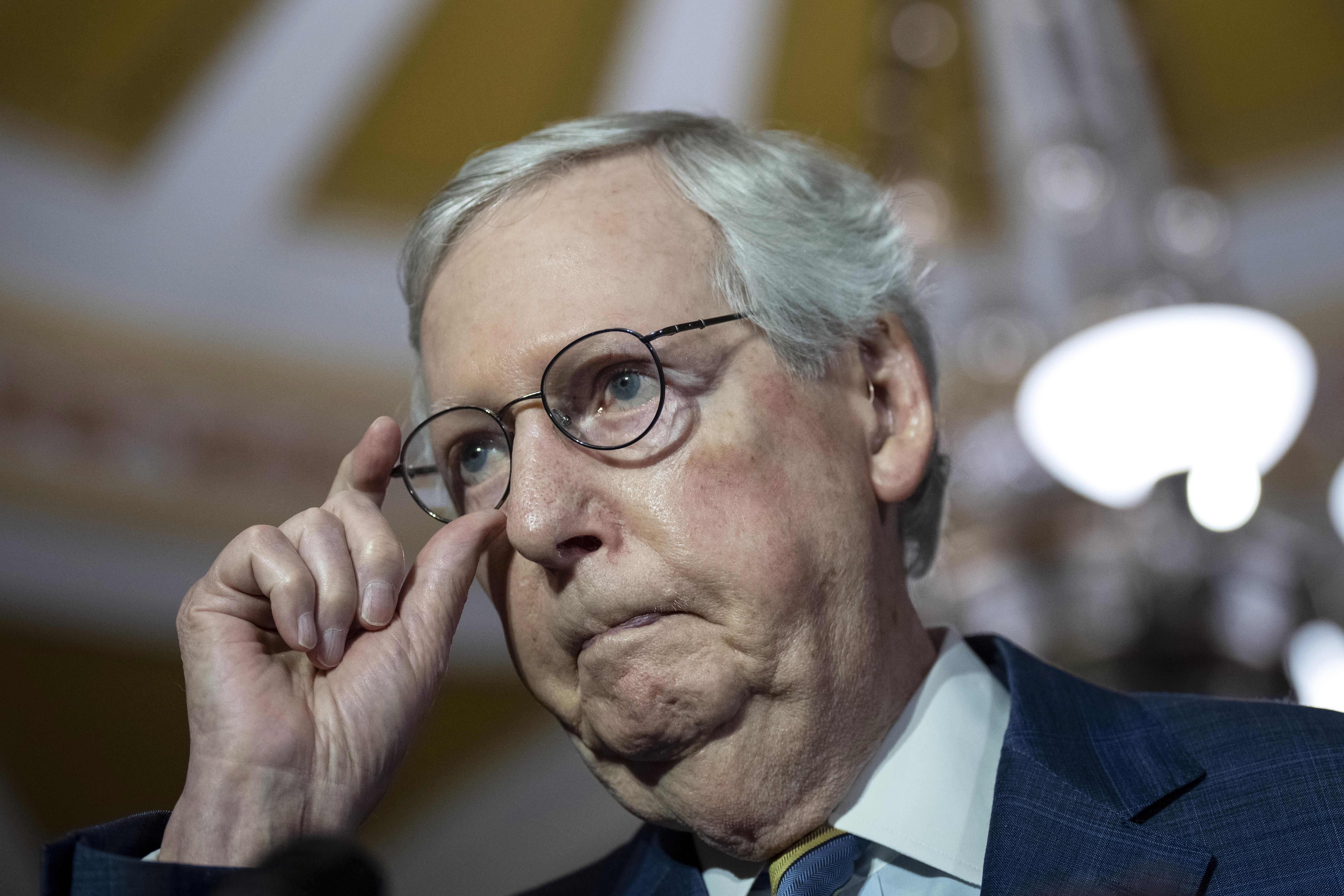 McConnell grabs onto his glasses.