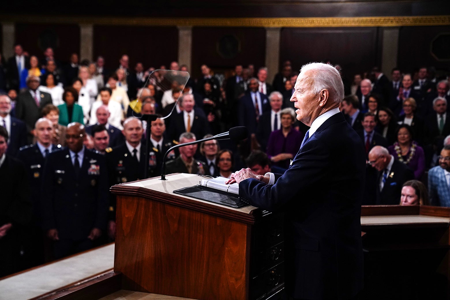 Biden seen from behind speaking from the podium to the joint session of Congress and his administration.