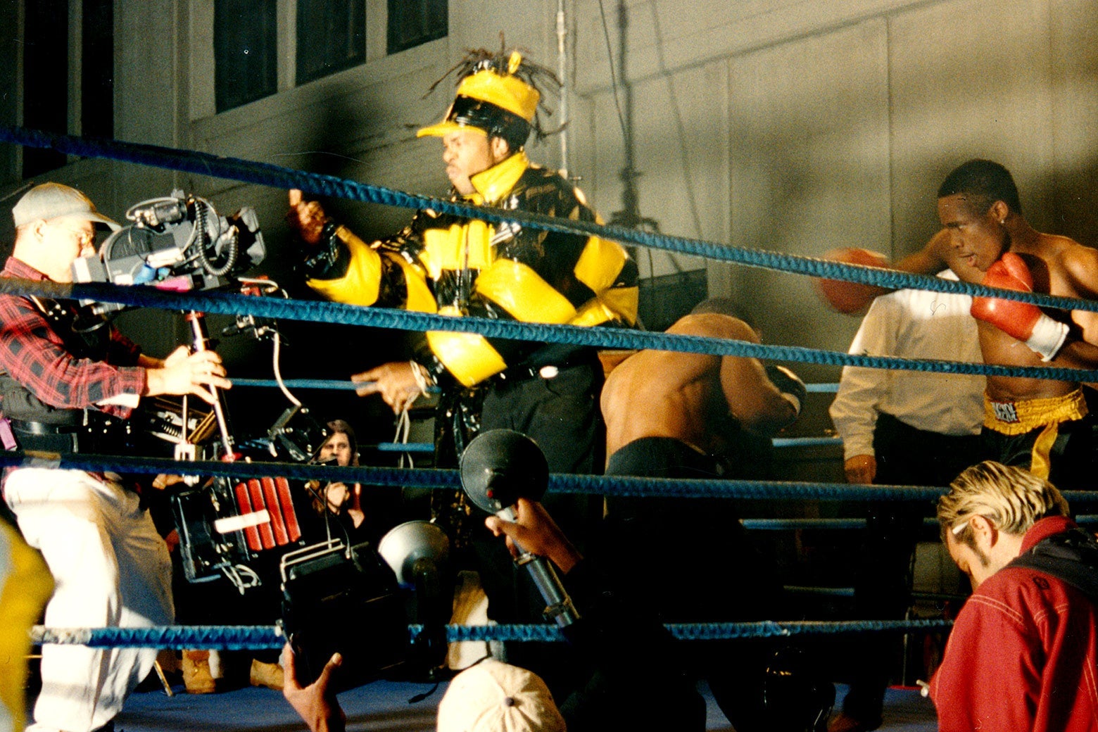 Busta Rhymes, in a shiny yellow coat, films his part for the "Rumble In the Jungle" video.