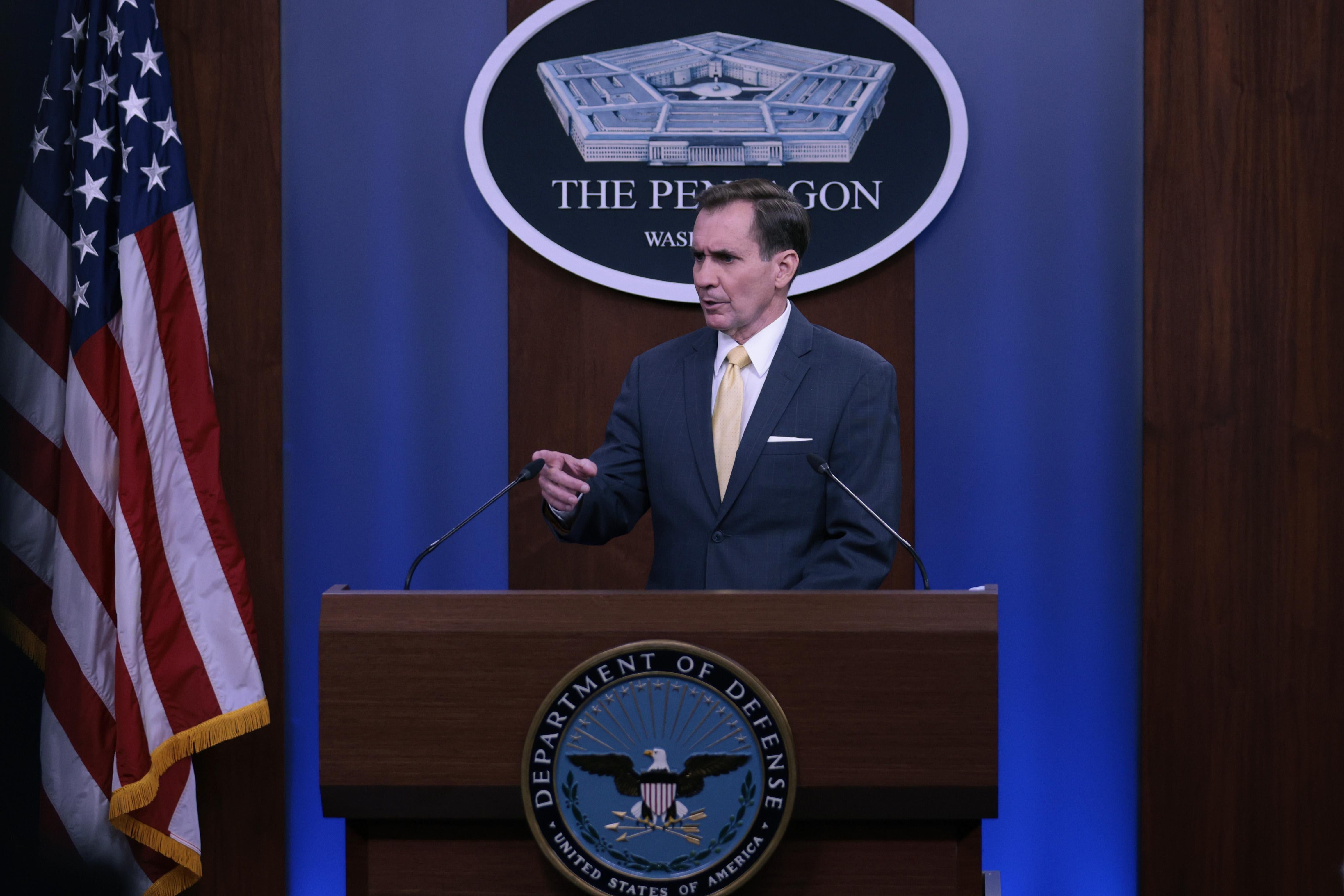 John Kirby speaks at a DOD lectern, in front of a U.S. flag and a sign reading "The Pentagon."